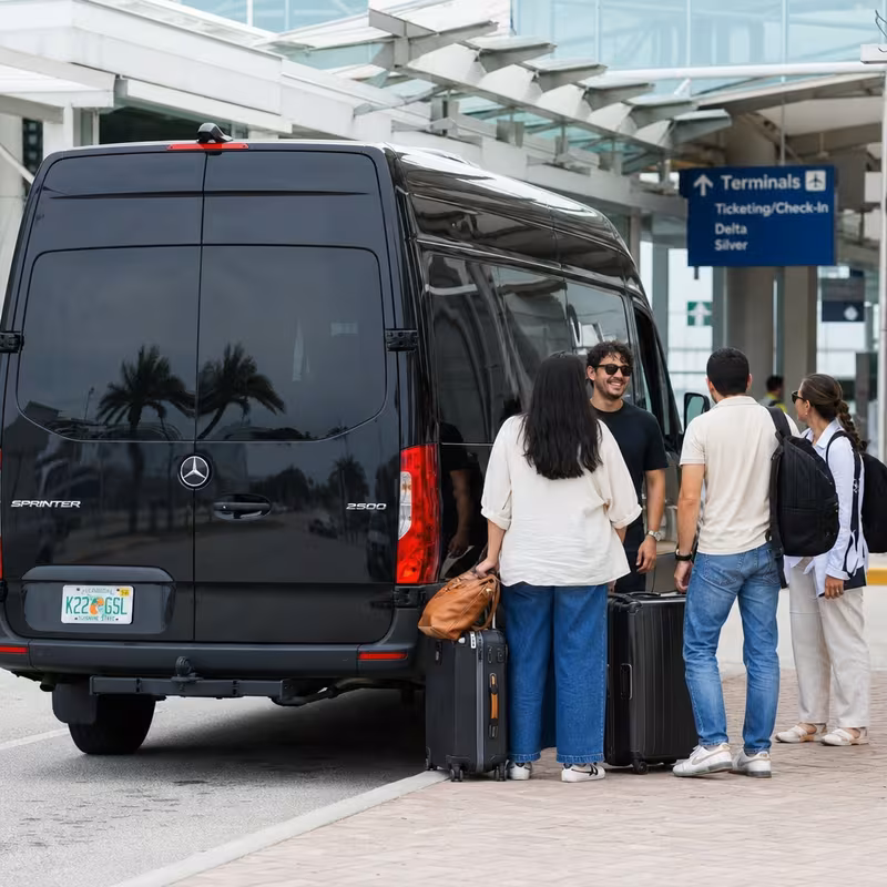 Group boarding a white charter bus for Airport Transportation transportation in Pembroke Pines