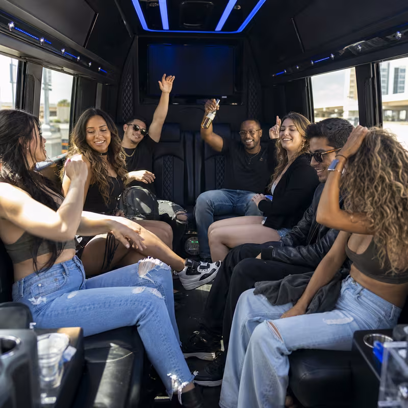 Group boarding a white charter bus for Concert Transportation transportation in Pembroke Pines