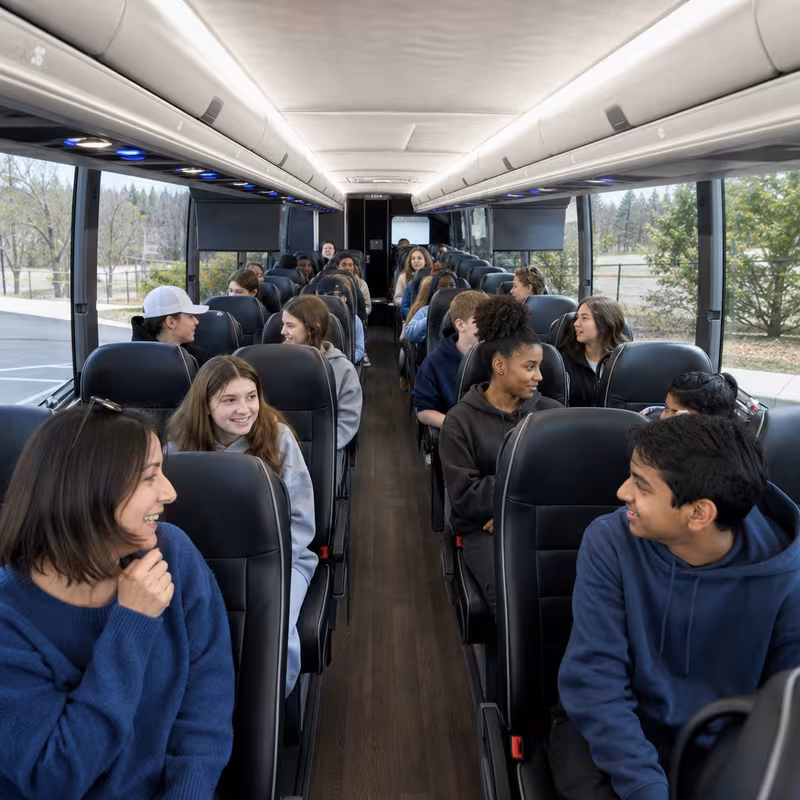 Group boarding a white charter bus for School Transportation transportation in Pembroke Pines