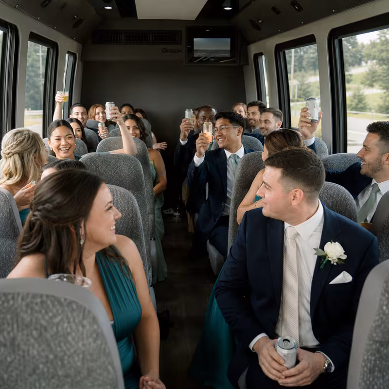 Group boarding a white charter bus for Wedding Transportation transportation in Pembroke Pines